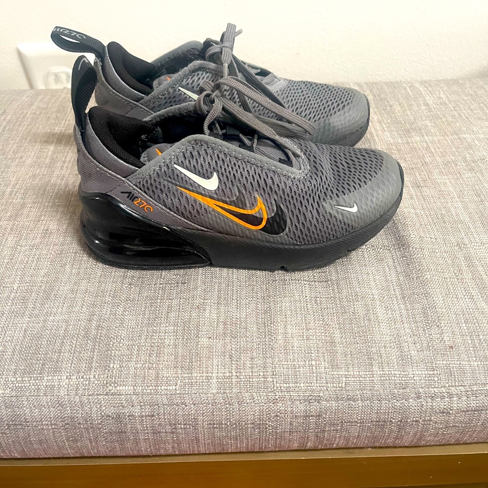 Gray and orange Nike 270